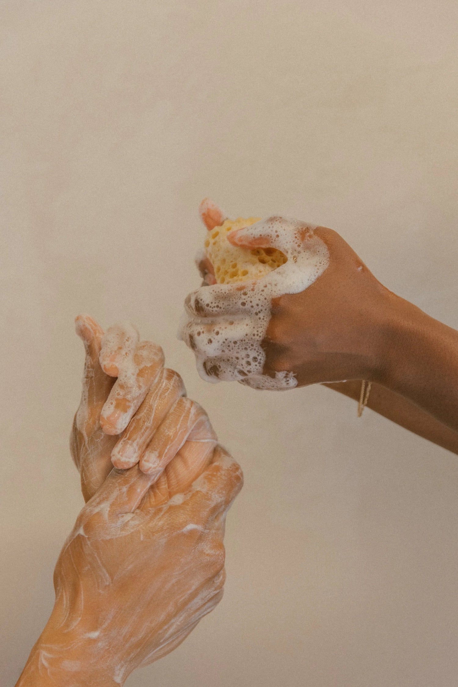 Man and woman lathering hands with Oshun luxury goat milk soap, highlighting clean beauty and skincare for sensitive skin.
